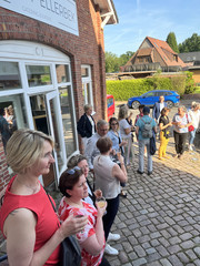 Haupt- und Ehrenamtliche stehen in lockerer Runde und unterhalten sich beim Jubiläumsabend fünf Jahre Albertinen Hospiz Norderstedt