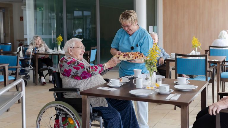 Serviceassistentin reicht Seniorin Kuchen - Immanuel Dienstleistungen sucht Küchen- und Servicekraft für Seniorenzentrum in Elstal